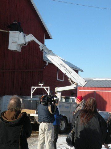 People Looking on Working Man on Truck — Shawano, WI — Raddant Electric Service Inc