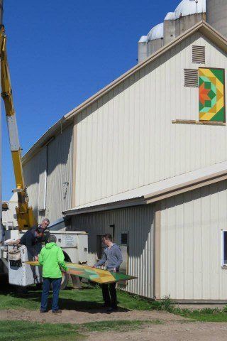 Men Holding Signage Part — Shawano, WI — Raddant Electric Service Inc