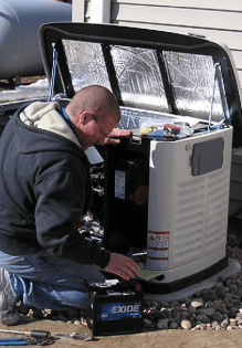 Man Replacing Battery — Shawano, WI — Raddant Electric Service Inc
