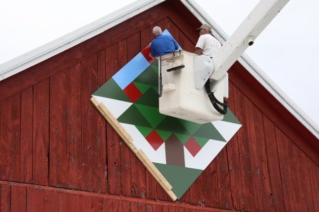 Two Men on White Truck Fixing Signage — Shawano, WI — Raddant Electric Service Inc