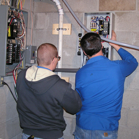 Electricians Checking Fuse Box — Shawano, WI — Raddant Electric Service Inc