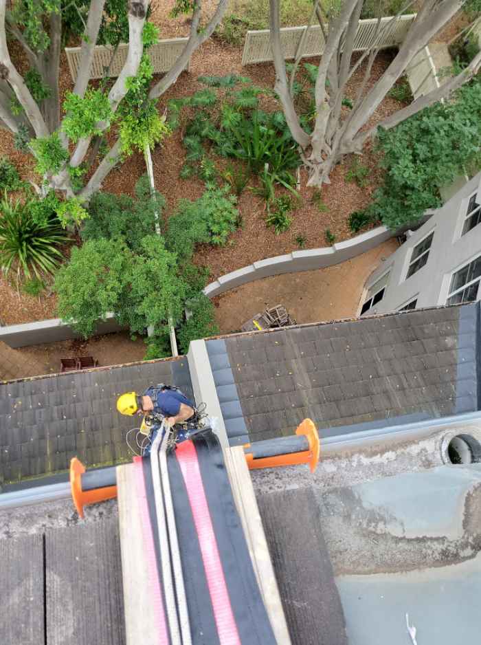 top view of a worker going down with the help of a rope