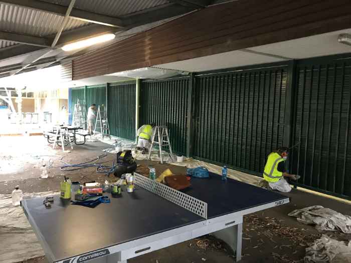 workers painting metal surface