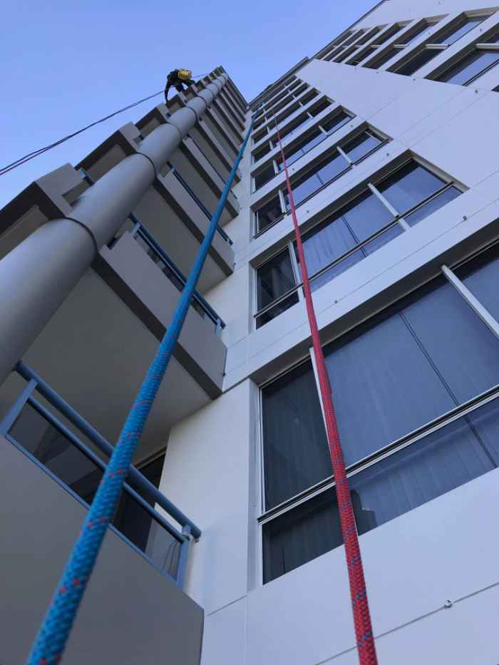 man climbing the exterior of a building