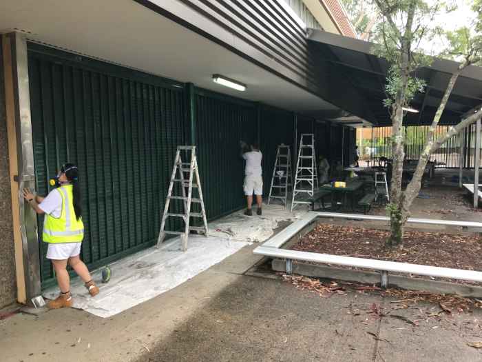 workers working on the exterior of a building