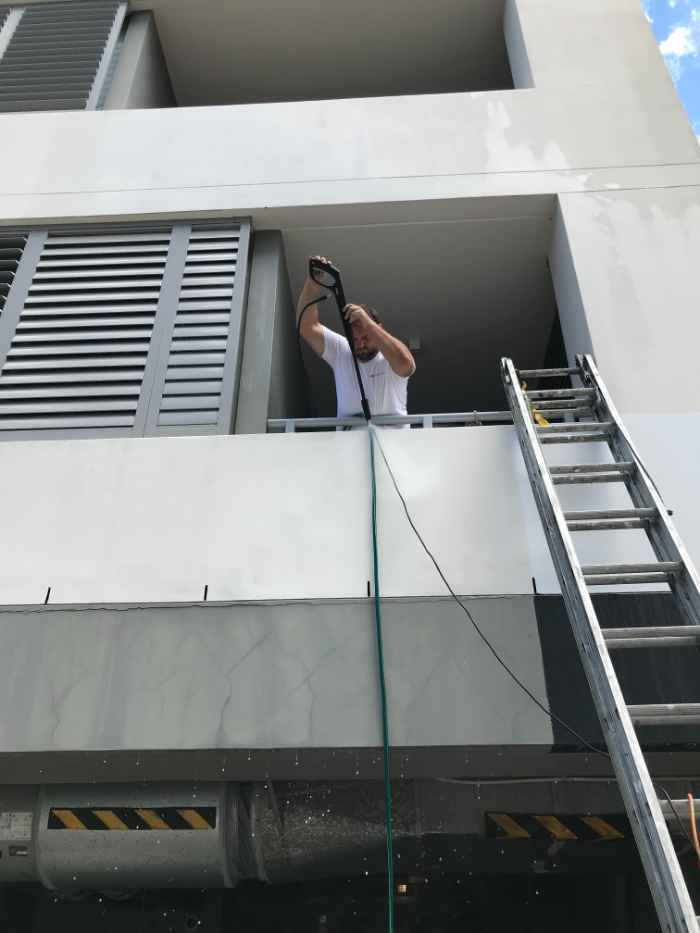 man drilling hole into the wall