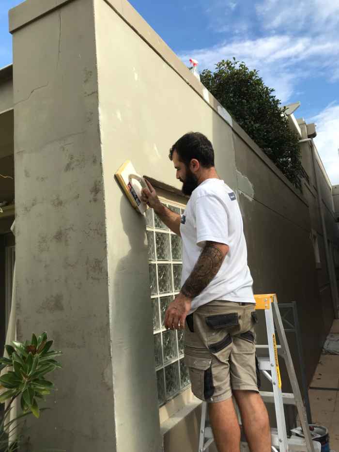 man repairing exterior walls
