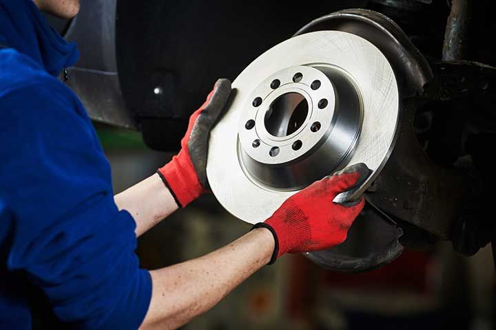 Automobile brake disk replacement in car repair shop or garage 
