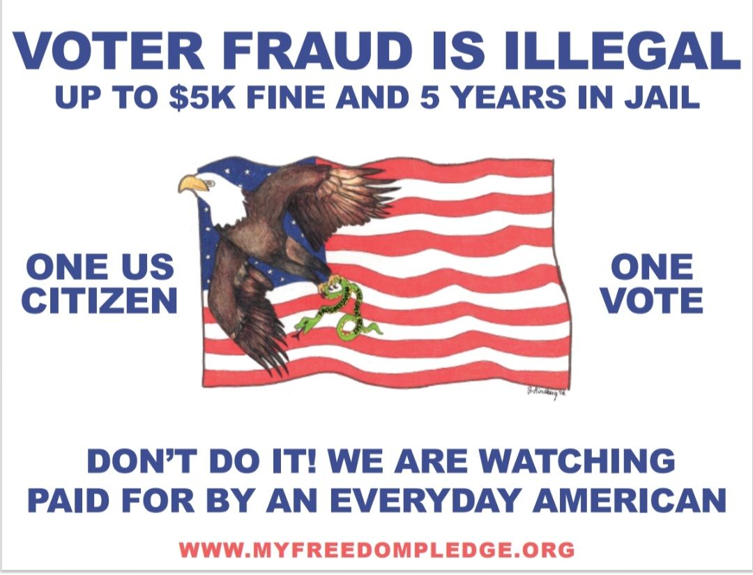 A row of voting booths are lined up in front of a brick building.