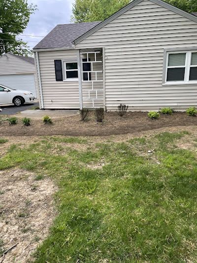 A white house with a white car parked in front of it.