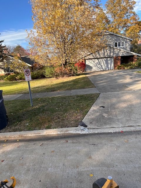 House with a driveway and lawn. 