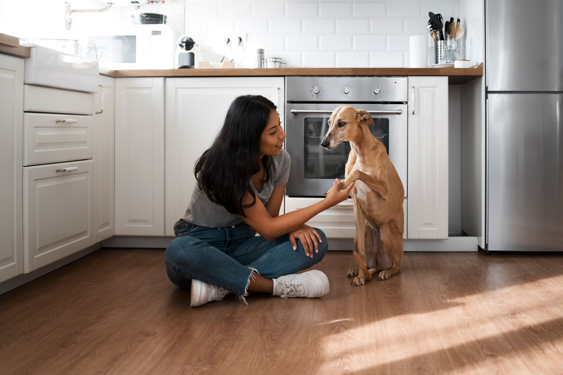 Lady Petting dog in Kitchen with new LVP.