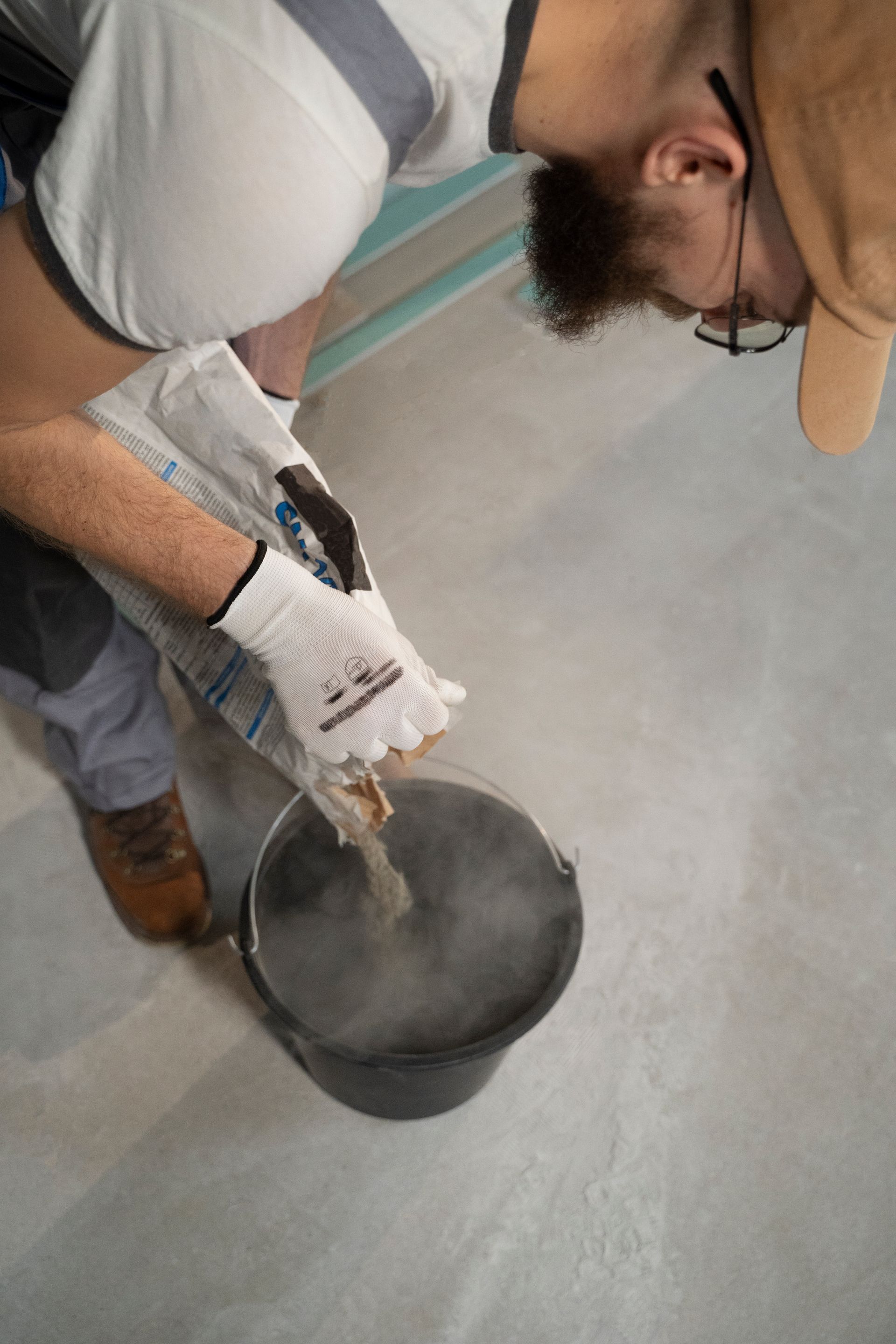 Installer mixing floor prep to ensure manufacture grade for floor installation. 
