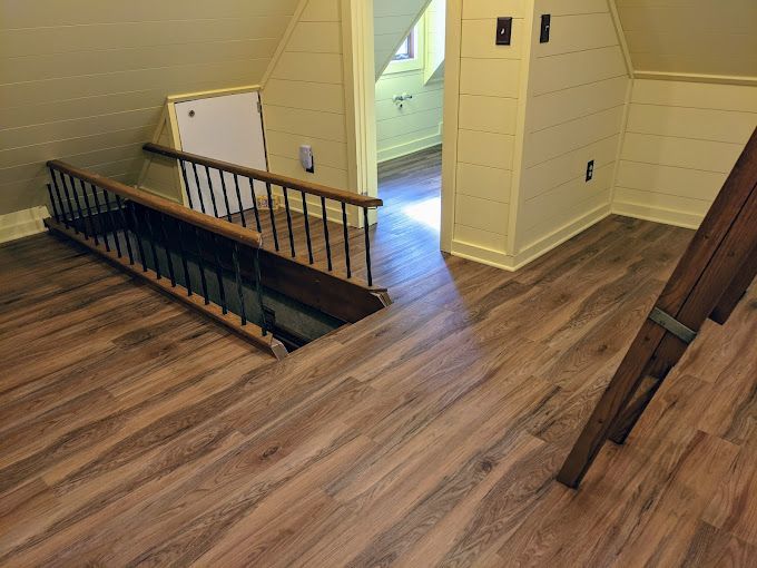 A wooden staircase leading up to a second floor in a house.