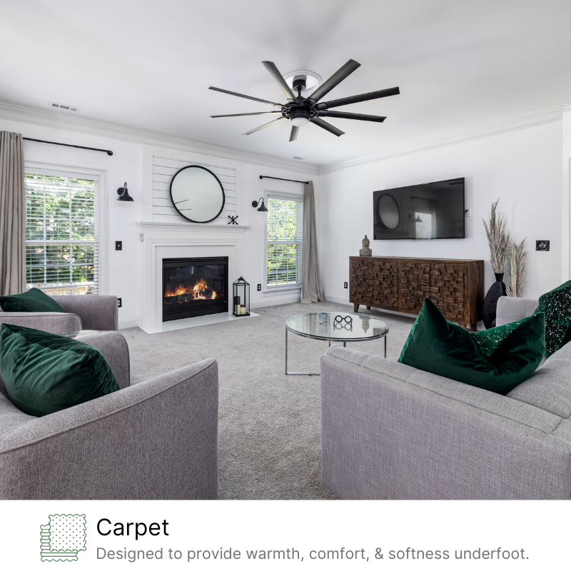 A living room with a fireplace and a ceiling fan