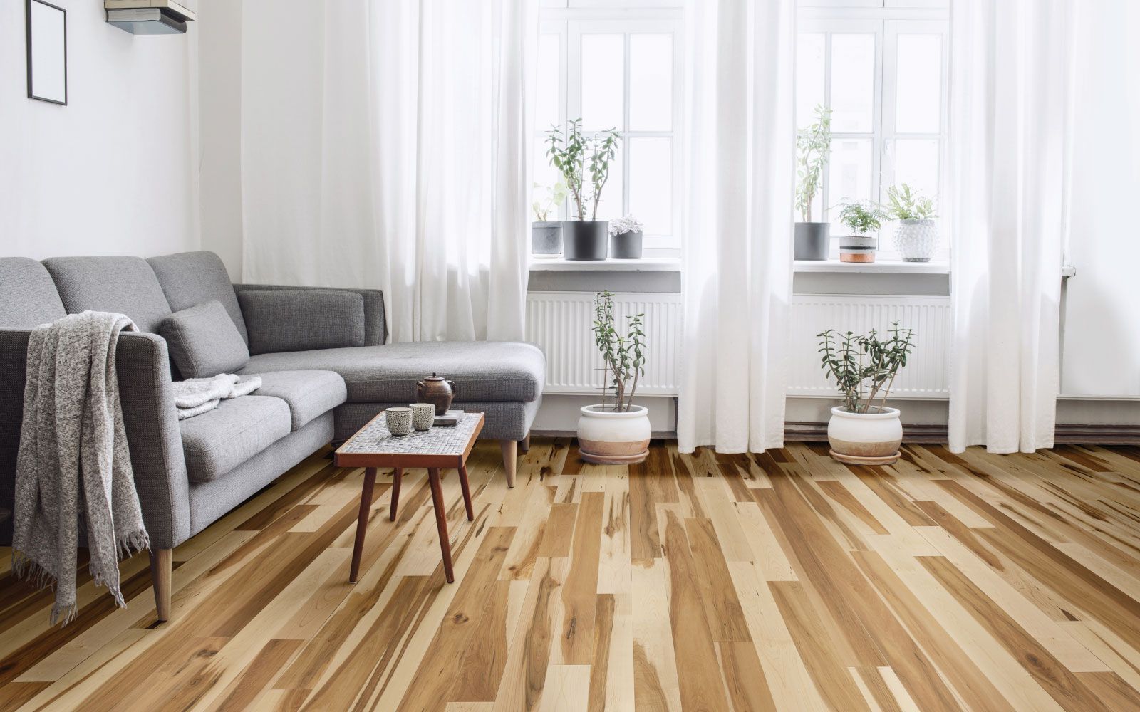 A living room with hardwood floors and a couch.