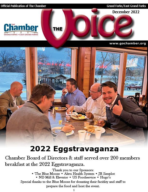 A group of men are sitting at a table eating breakfast.