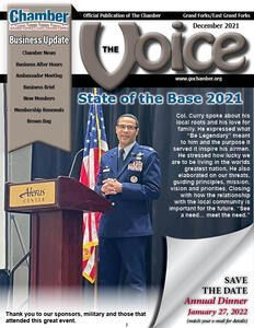 A man in a military uniform is standing at a podium in front of an american flag.