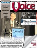 A man is giving a speech at a podium in front of a microphone on the cover of a magazine.