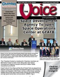 The cover of the voice magazine shows a group of people sitting at a table.