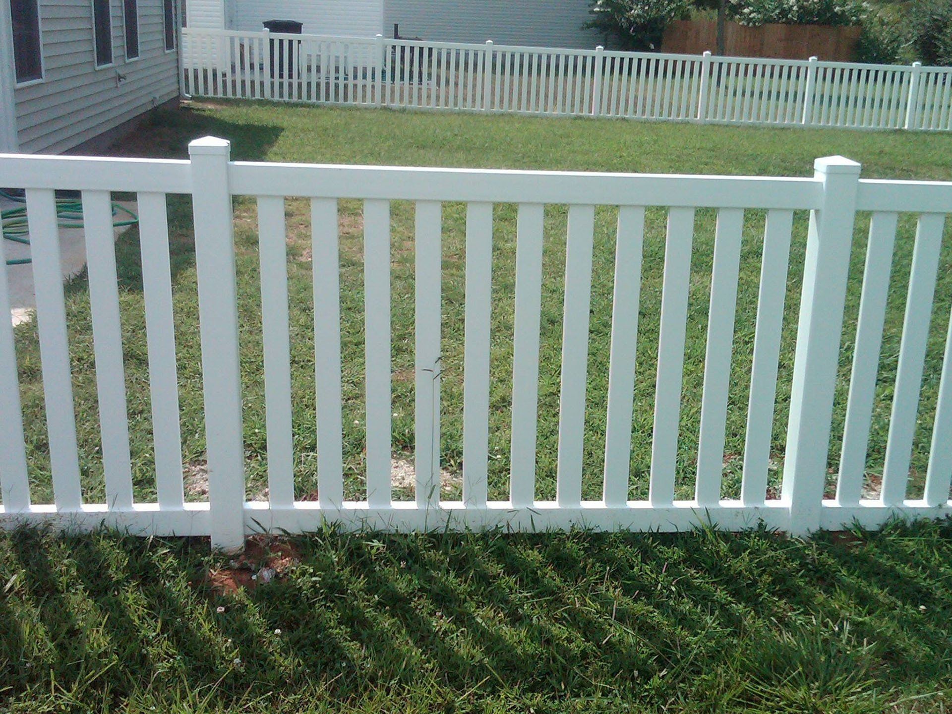 White Backyard Vinyl Fence — Wilmington,  NC — J & J Fence