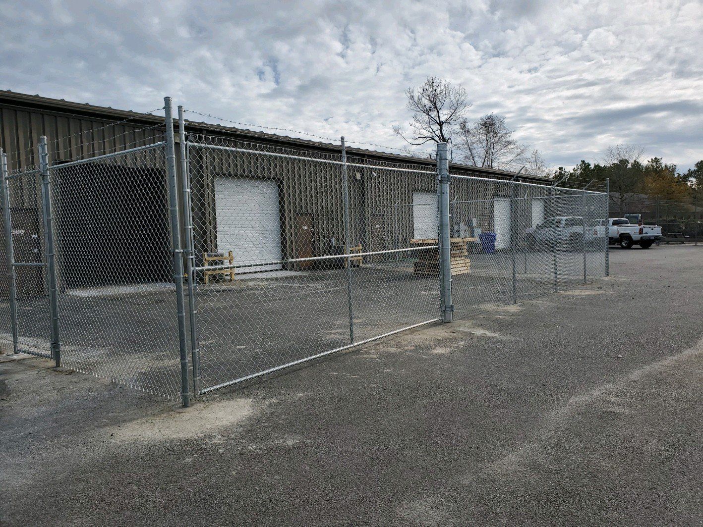 Warehouse With A Chain Link And Bulb Wire Fence — Wilmington,  NC — J & J Fence