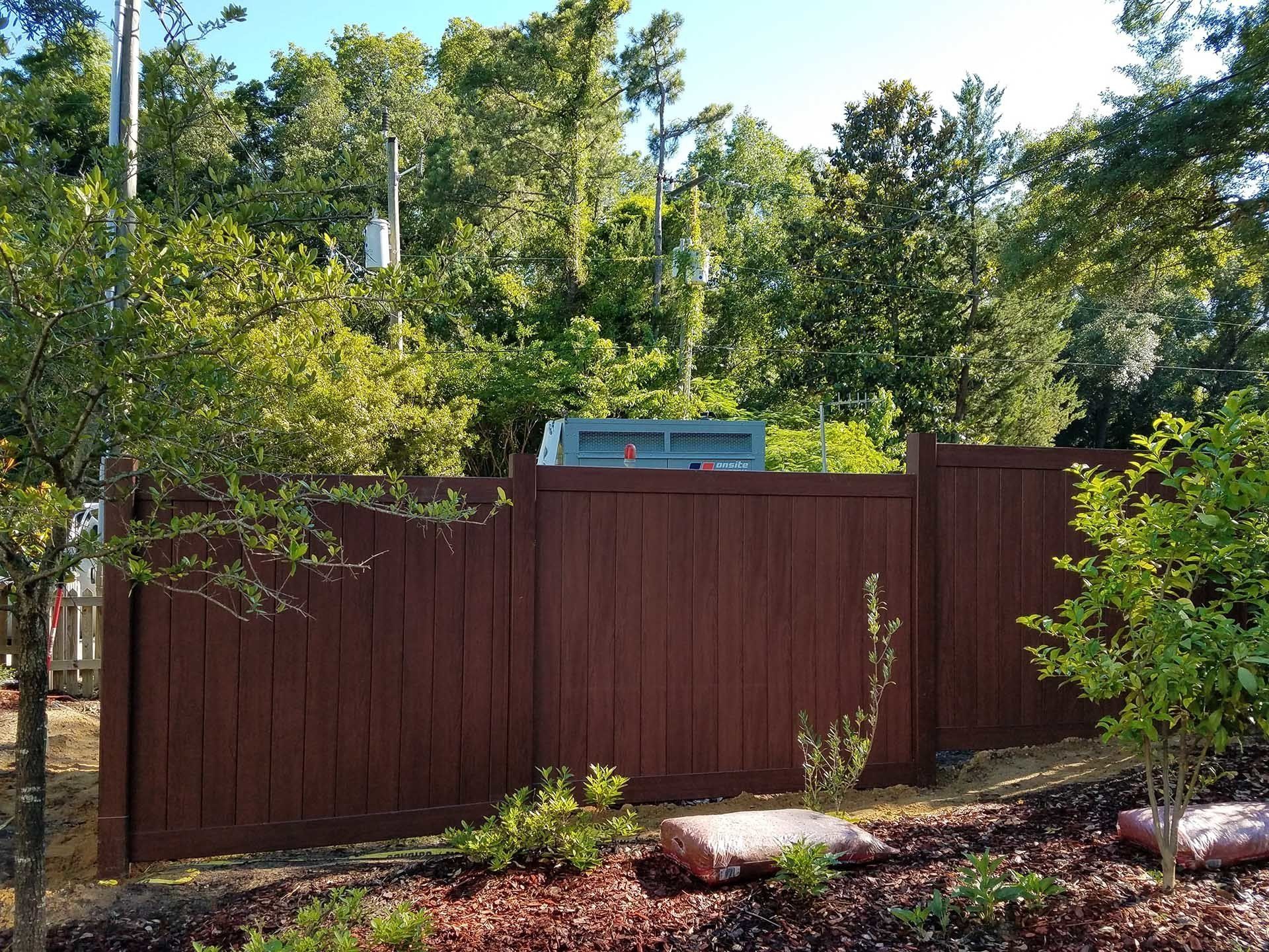 Wooden Fence With Lots Of Trees — Wilmington,  NC — J & J Fence
