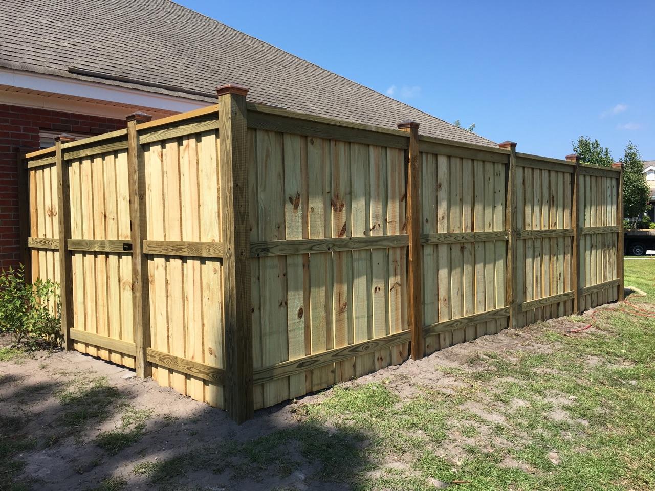 Brick House With Wooden Fence — Wilmington,  NC — J & J Fence