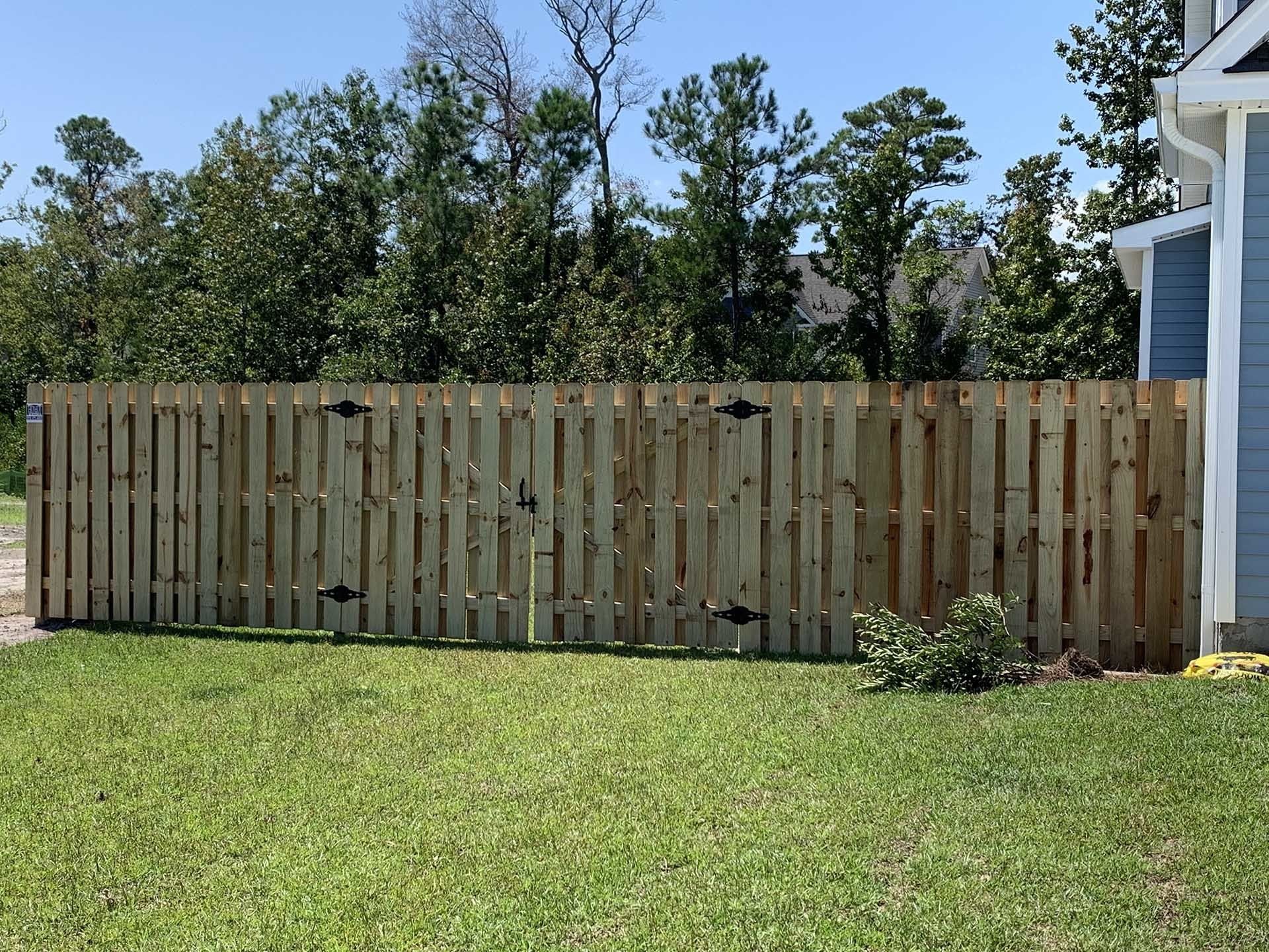 Blue House With Small Wooden Fence Gate — Wilmington,  NC — J & J Fence