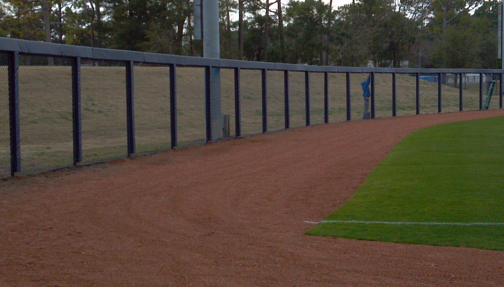 Man Installing A Fence — Wilmington,  NC — J & J Fence