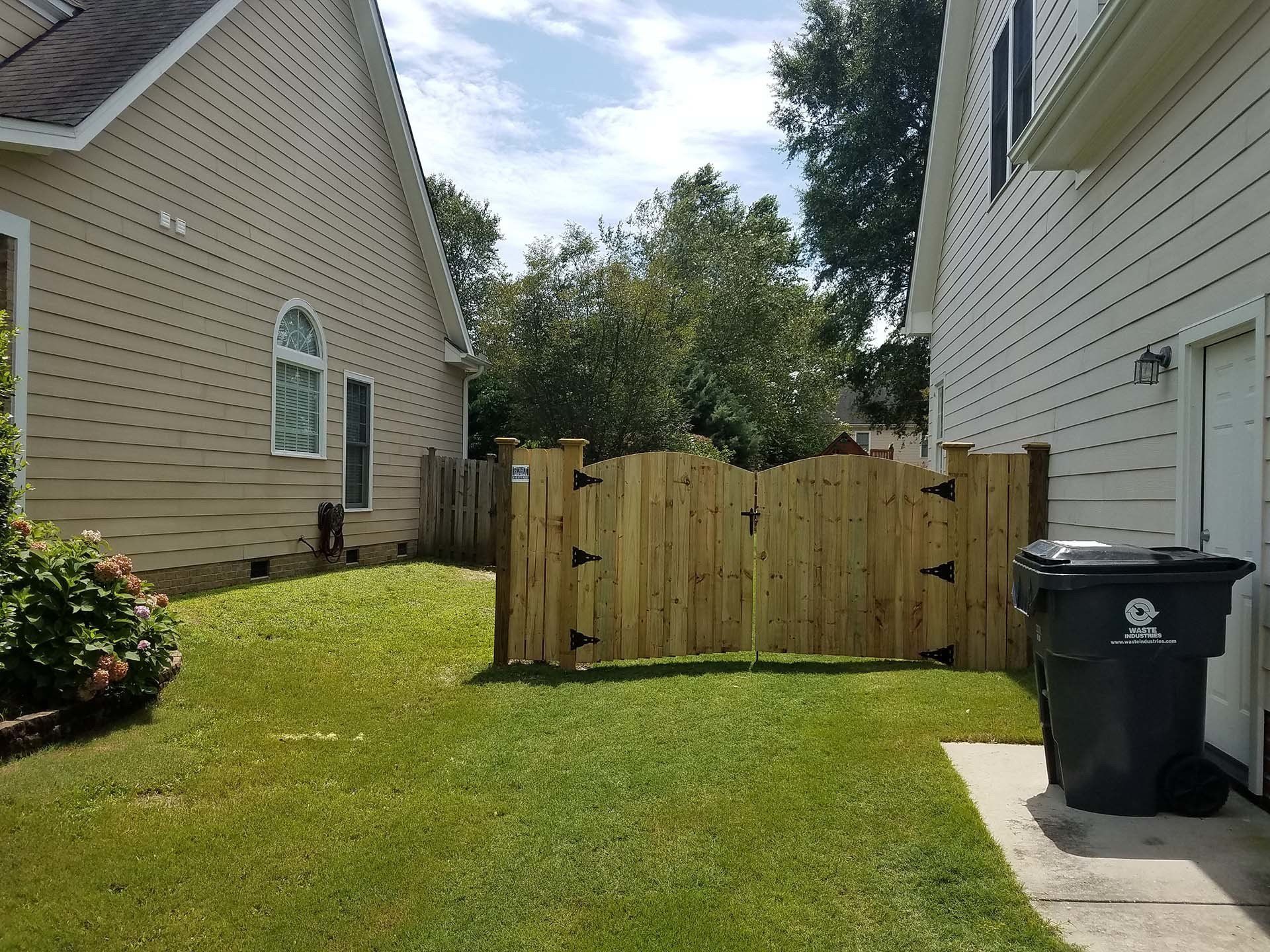 Brown House With Wooden Fence Gate — Wilmington,  NC — J & J Fence