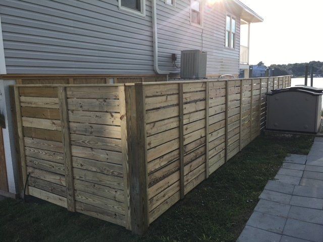 House With Wooden Fence — Wilmington,  NC — J & J Fence