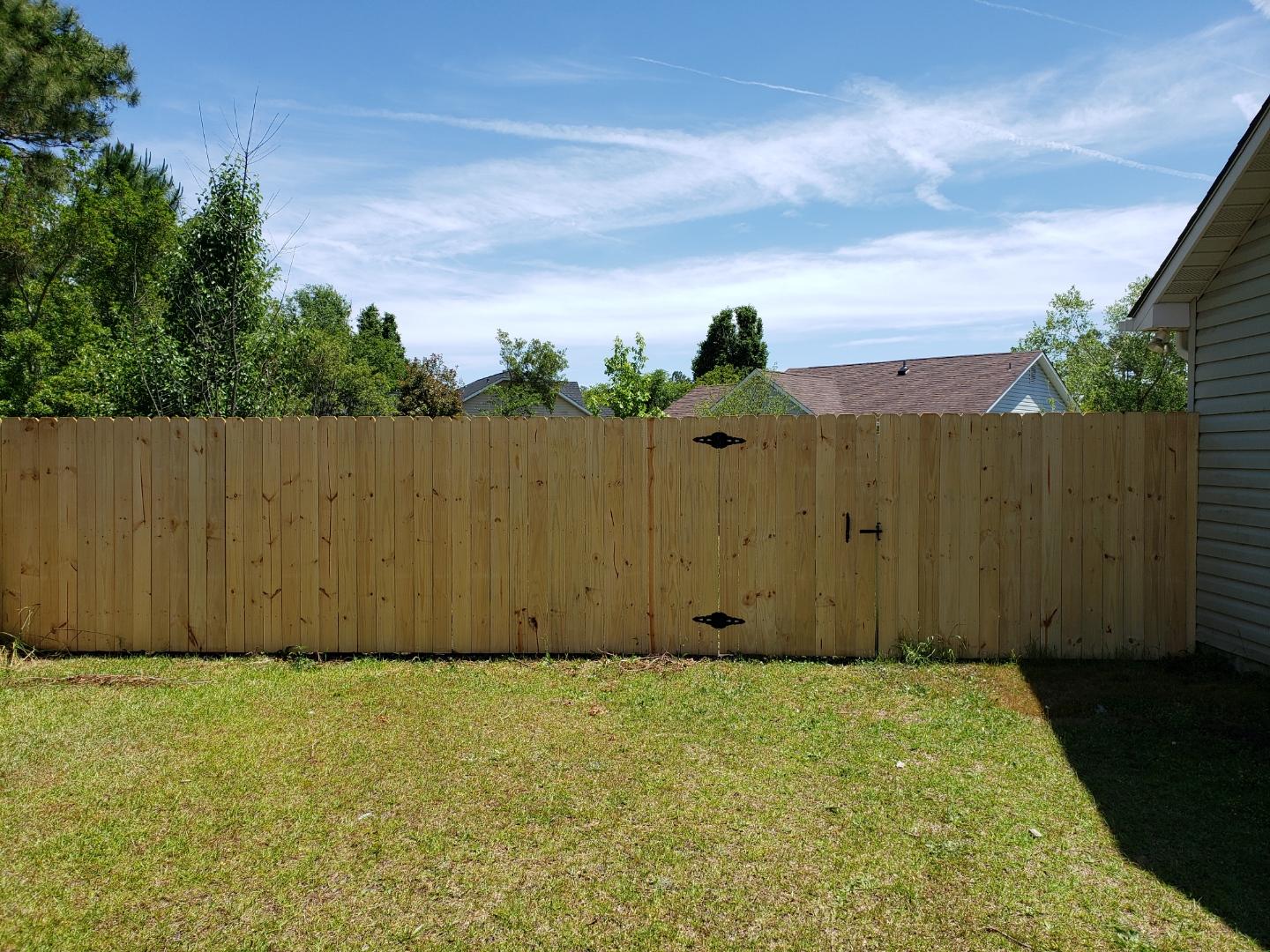White House With Wooden Backyard Fence — Wilmington,  NC — J & J Fence