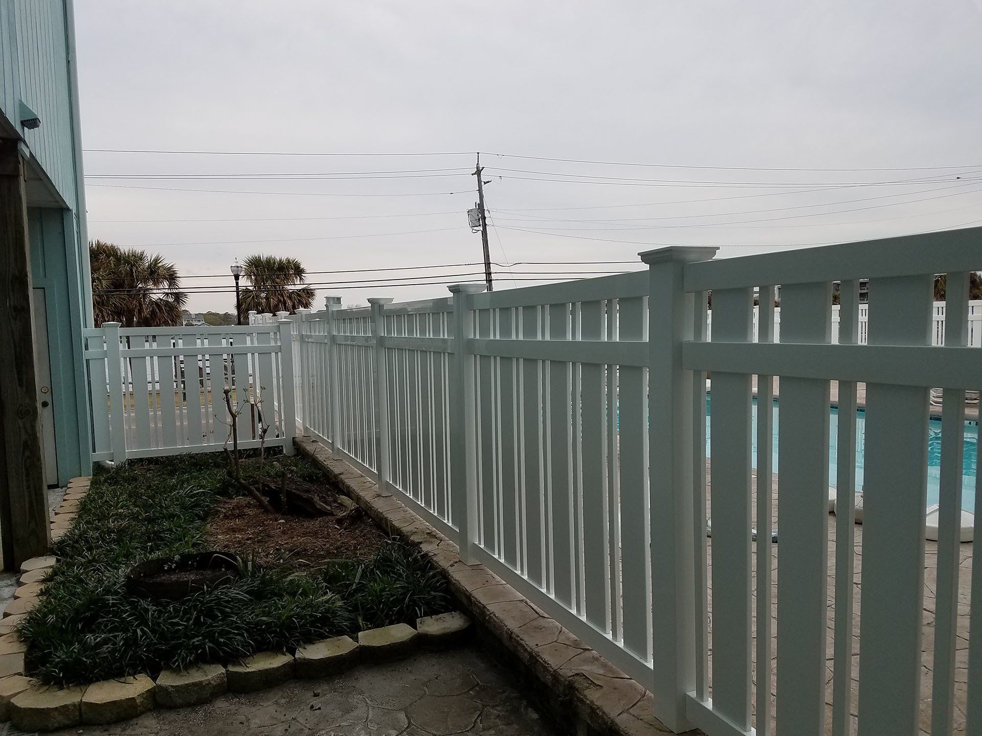 Gray House With Vinyl Fence — Wilmington,  NC — J & J Fence