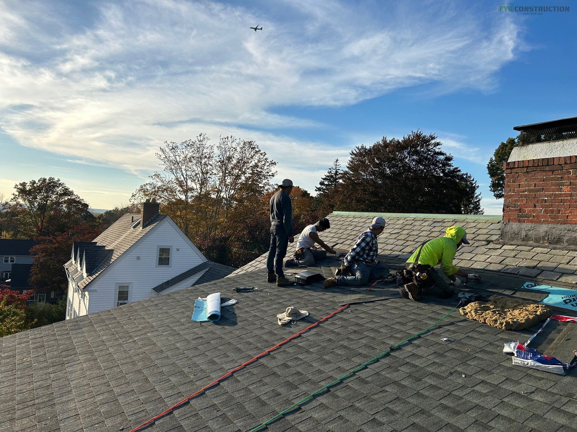 Roofers fixing a roof in South Kingstown