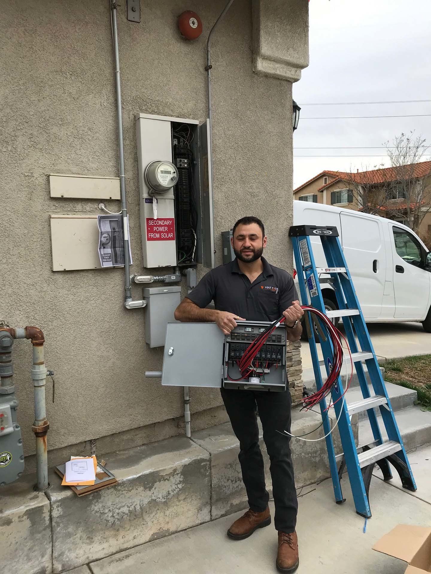 Electrician Holding a Breaker Box — Riverside, CA — Volt Tech Electric