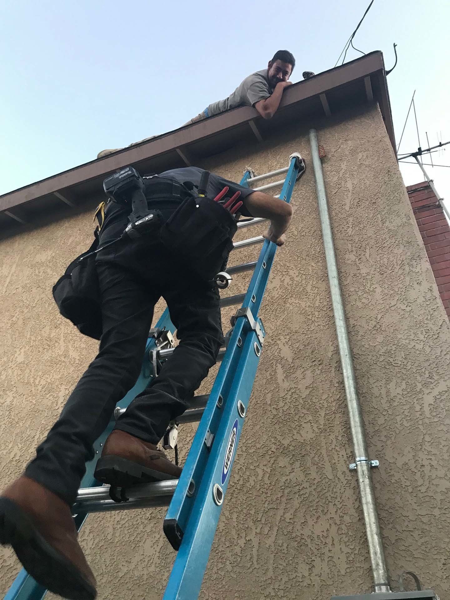Electrician Climbing Up a Ladder — Riverside, CA — Volt Tech Electric