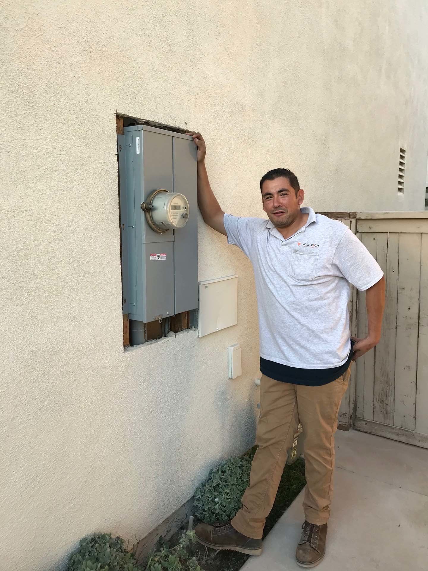 Electrician Beside a Breaker Box — Riverside, CA — Volt Tech Electric