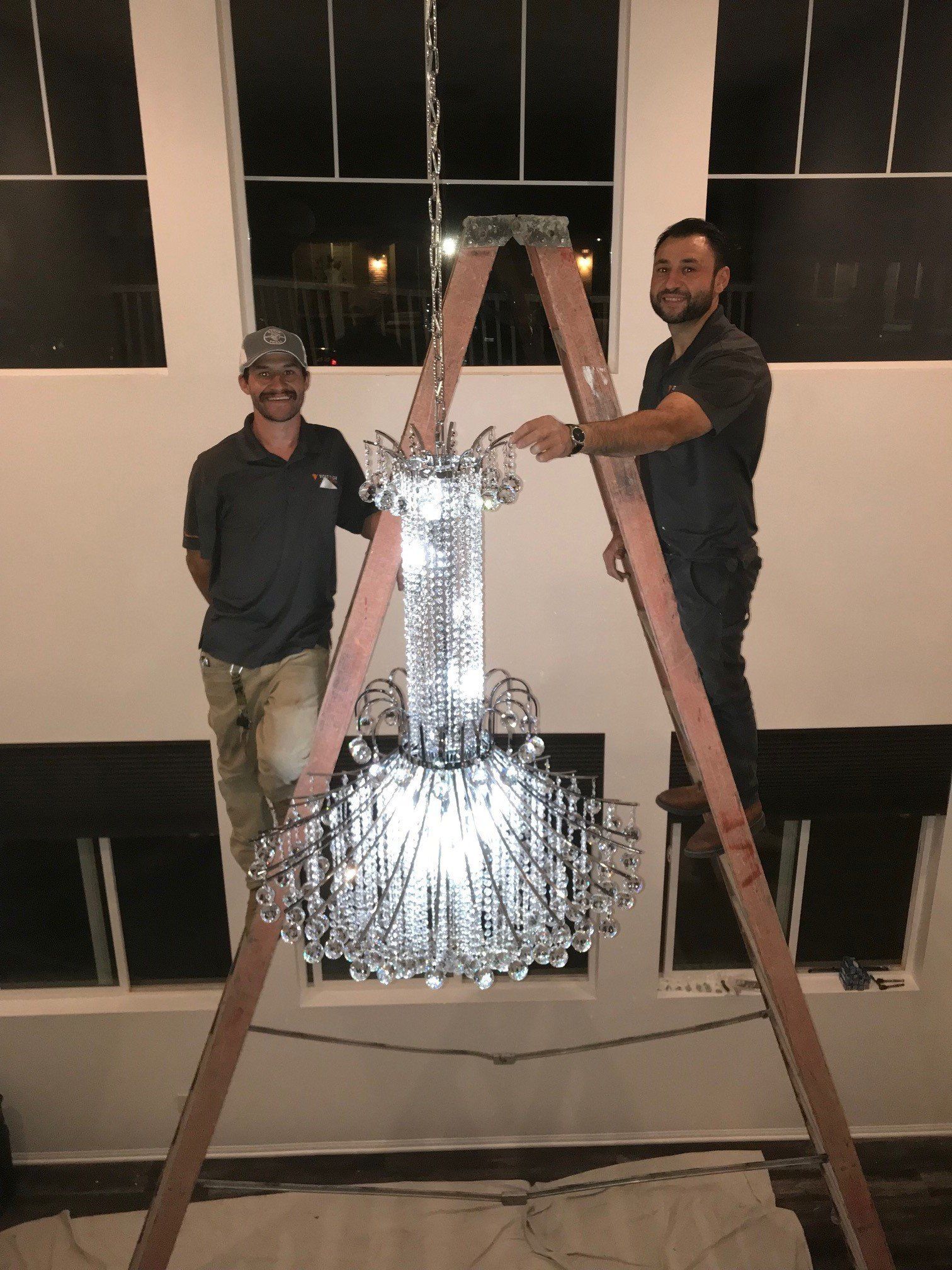 Two Electrician in a Ladder Installing a Chandelier — Riverside, CA — Volt Tech Electric