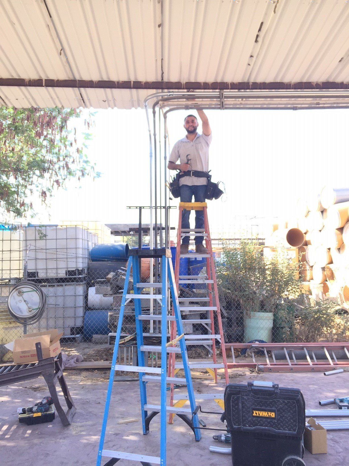 Electrician Installing a Metal Tube Wiring — Riverside, CA — Volt Tech Electric