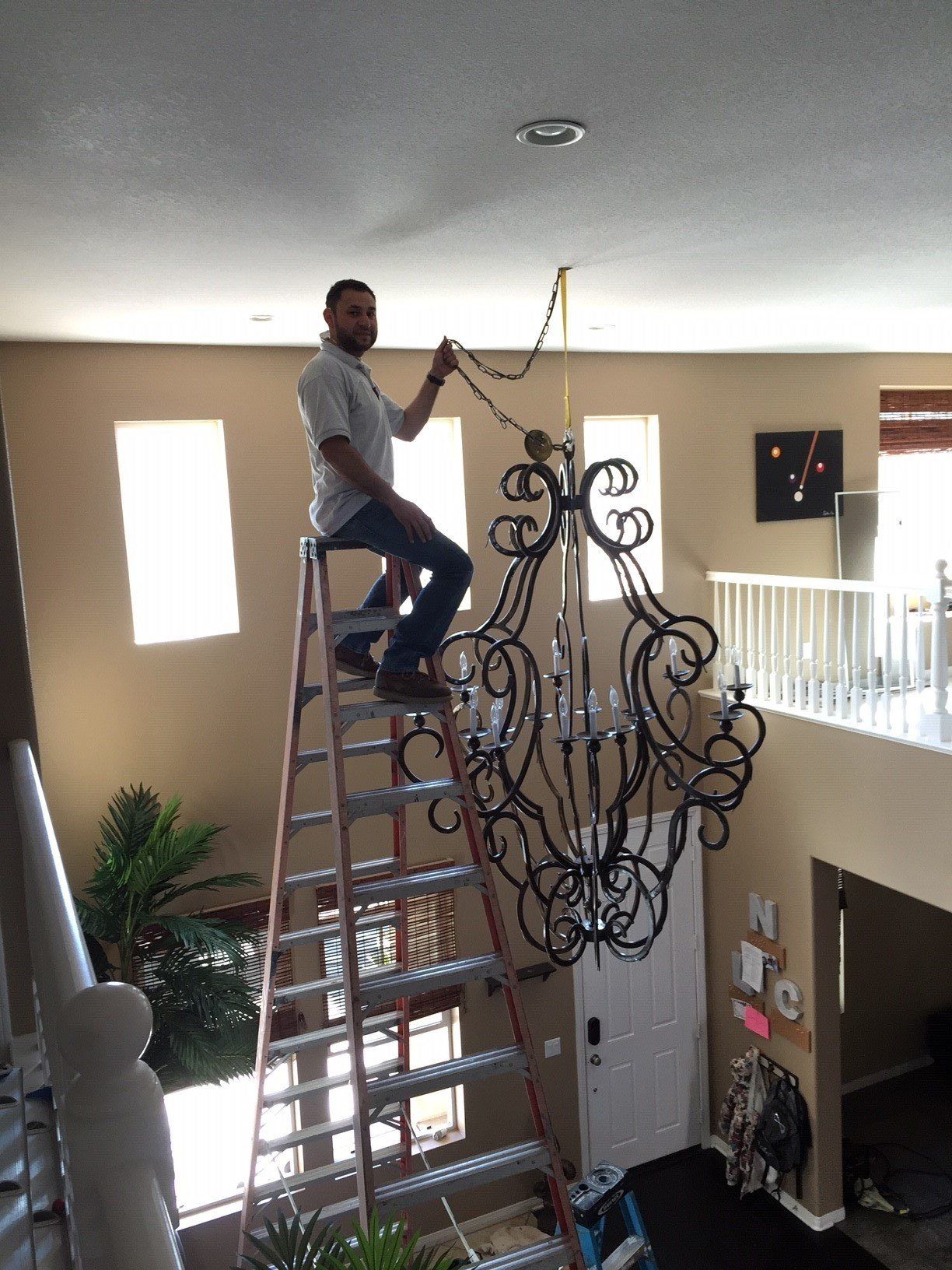 Man Installing a Chandelier — Riverside, CA — Volt Tech Electric