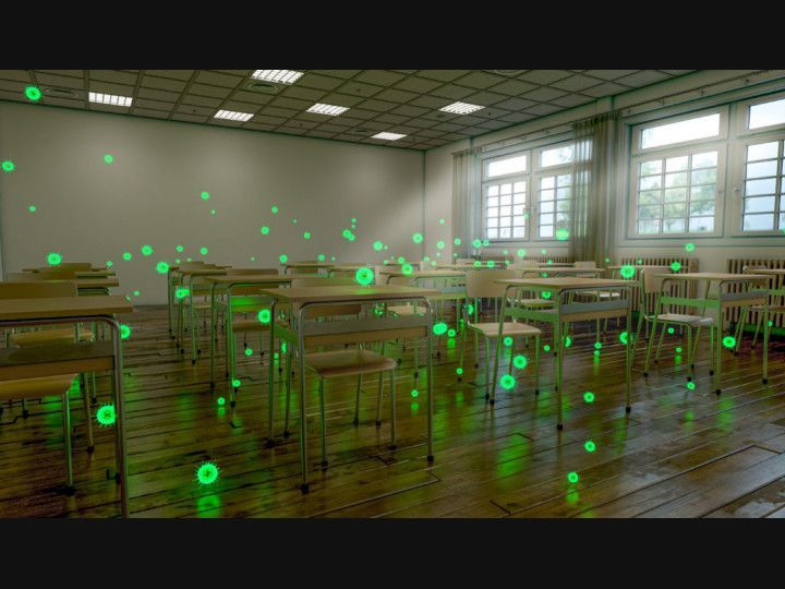 A classroom with a lot of desks and chairs with green lights on them