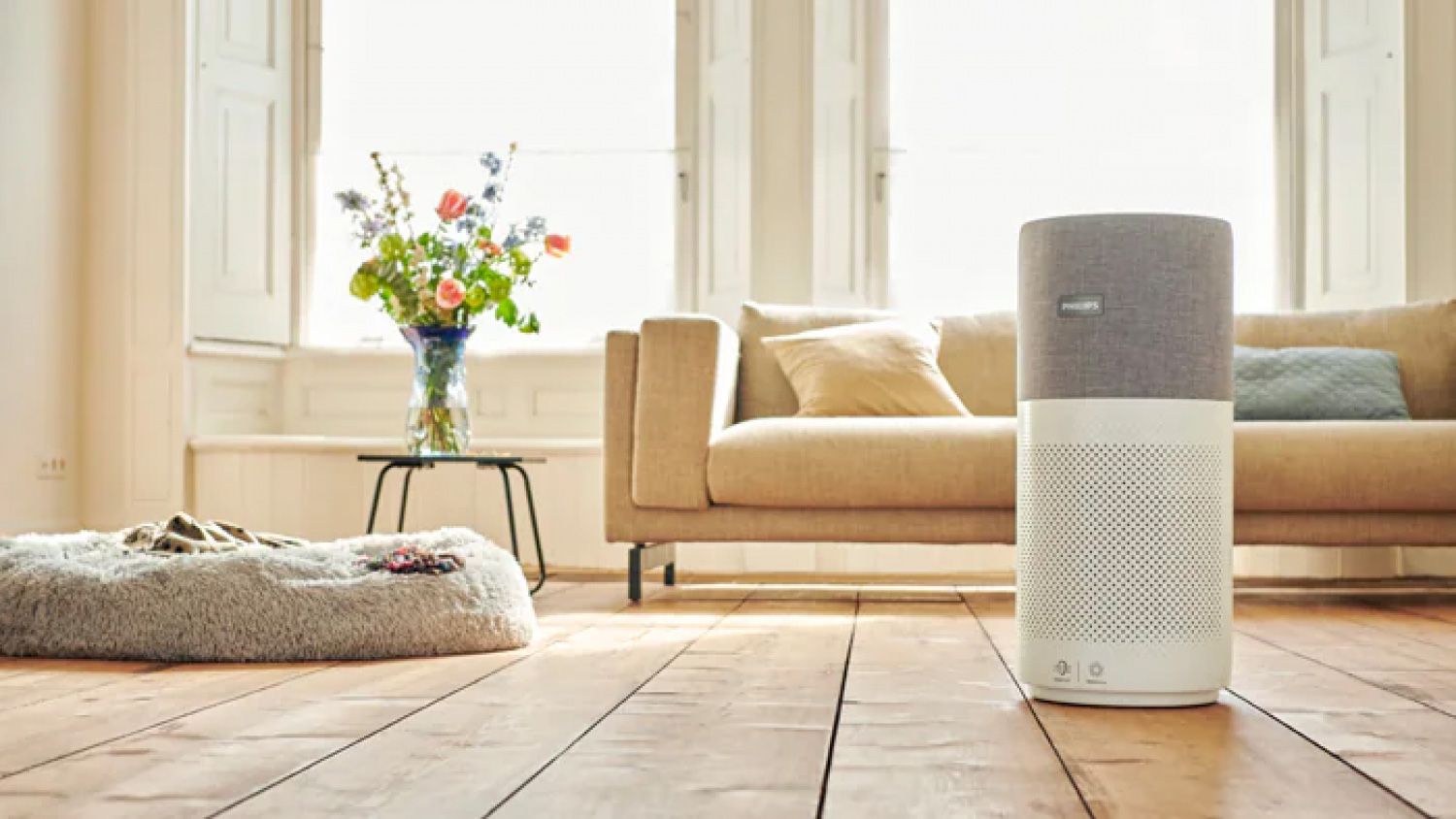 Air purifier sits on a wooden floor in a living room