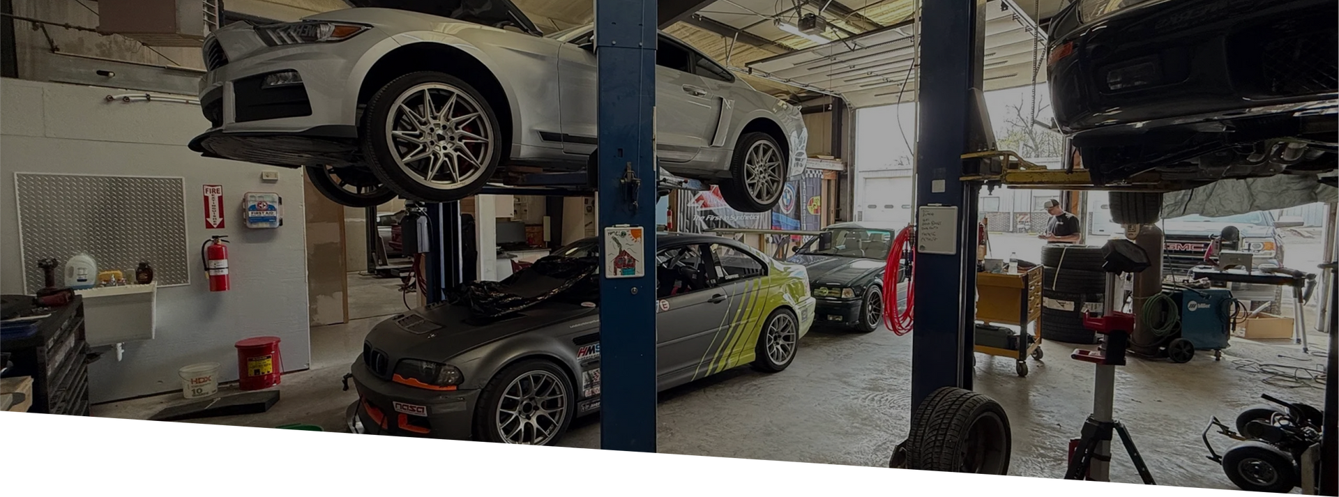 Cars on lifts in a mechanic shop. | Euro Speed Werks