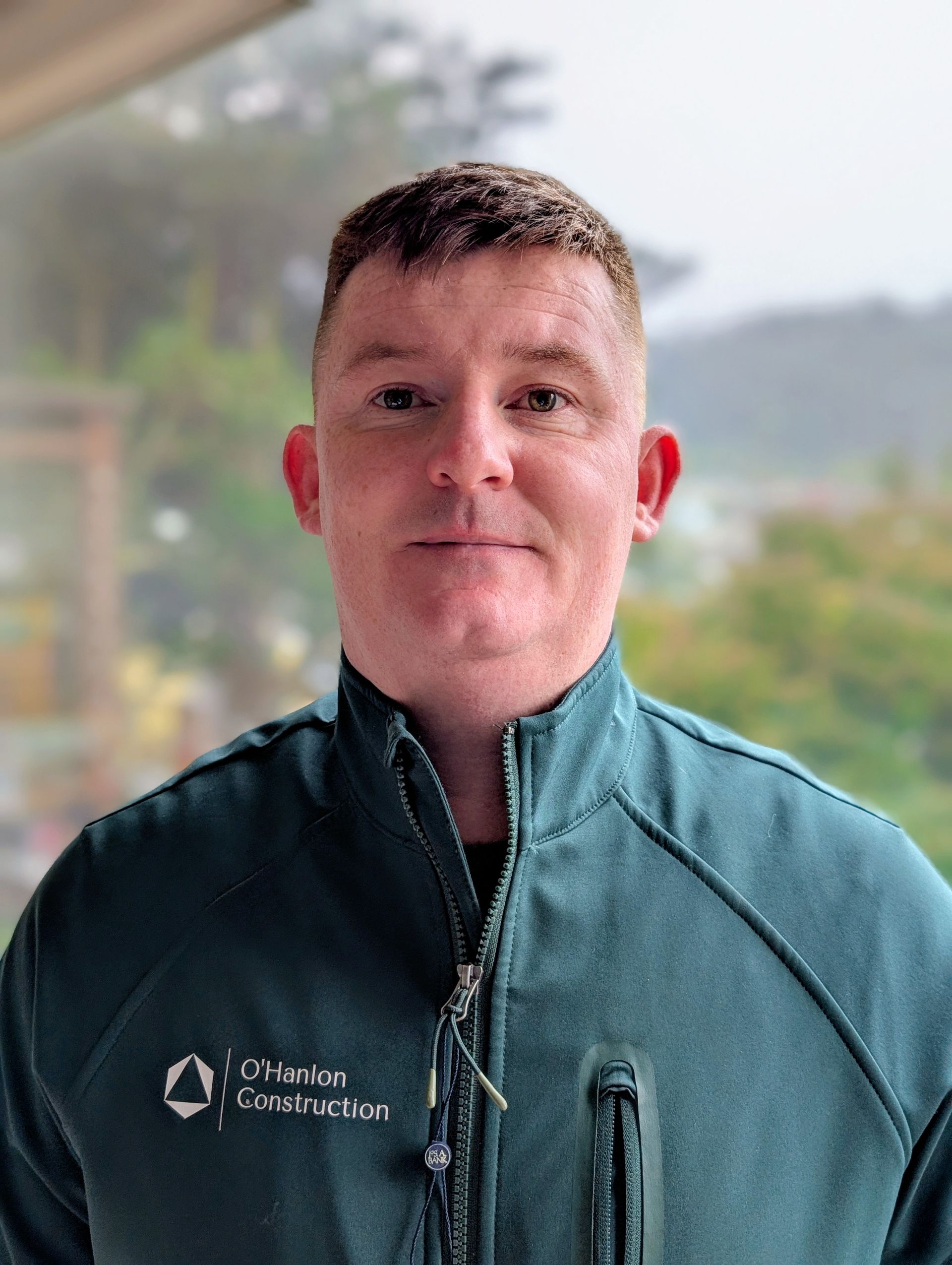 A living room with a couch , chair , coffee table and fireplace.