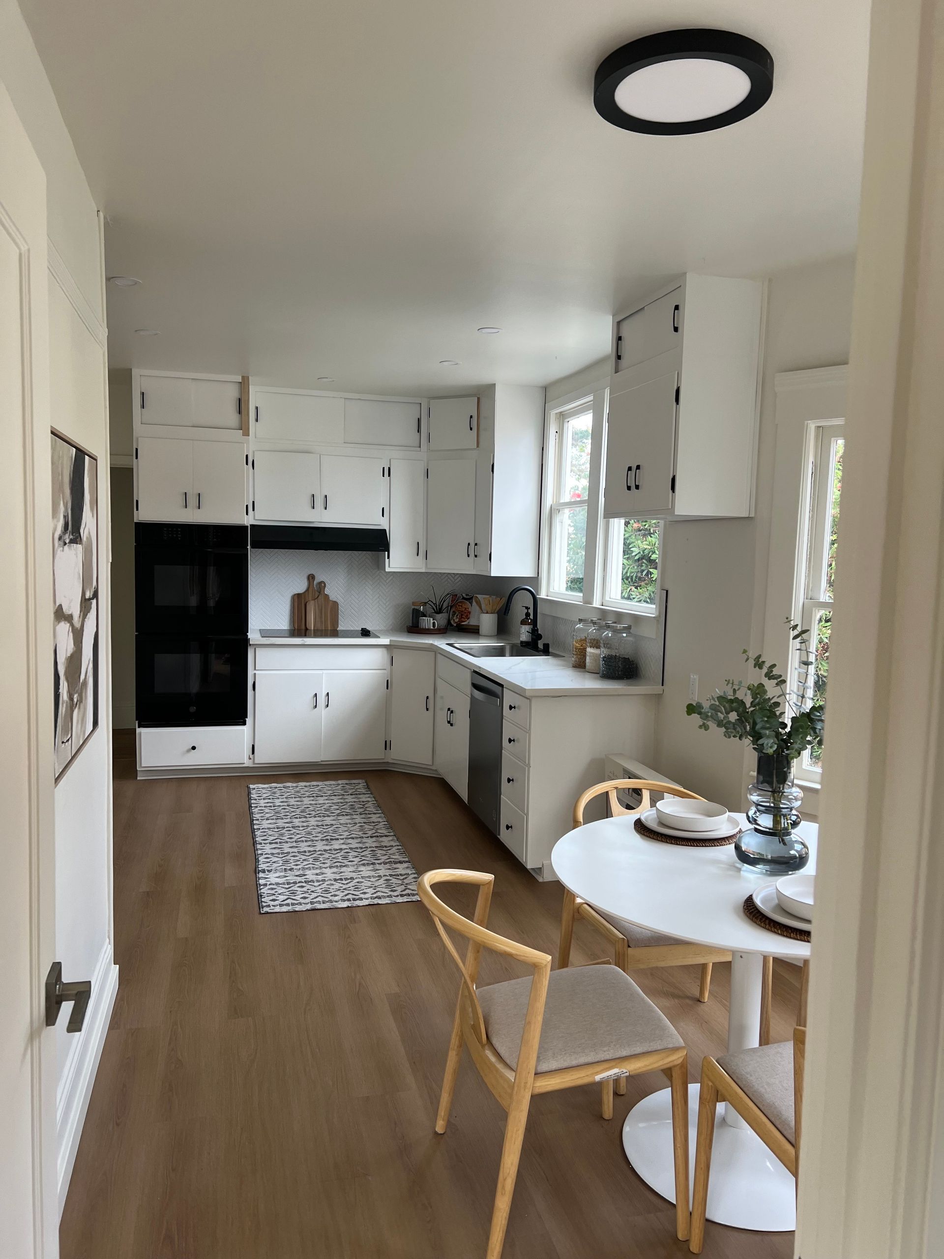 A kitchen with a table and chairs in it