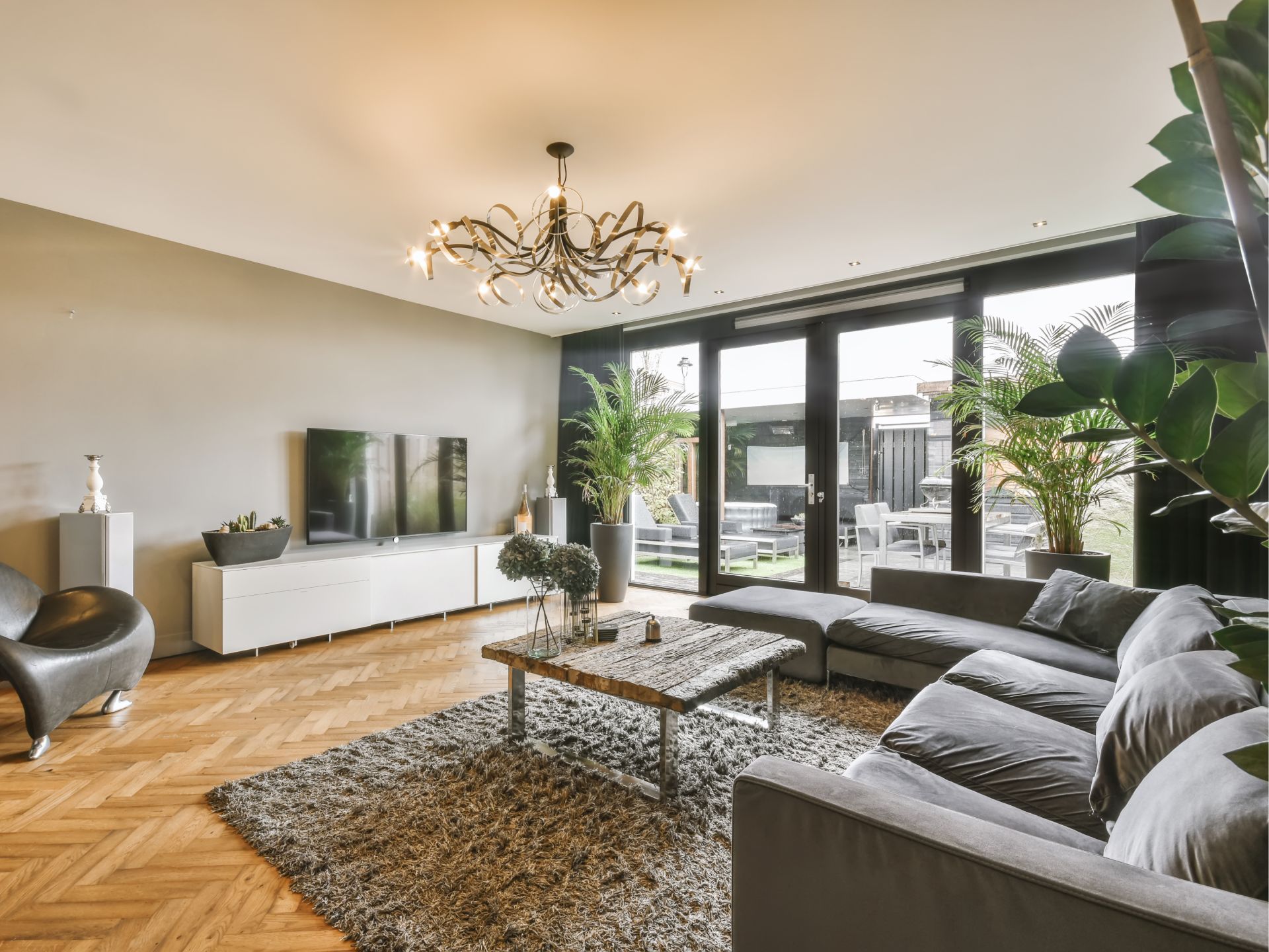 A living room with a couch , chair , coffee table and television.