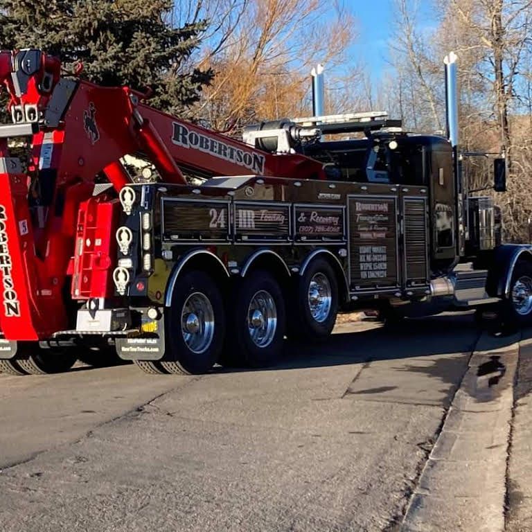 A robertson tow truck is parked on the side of the road — Evanston, WY — Robertson Transportation Inc. Towing and Recovery