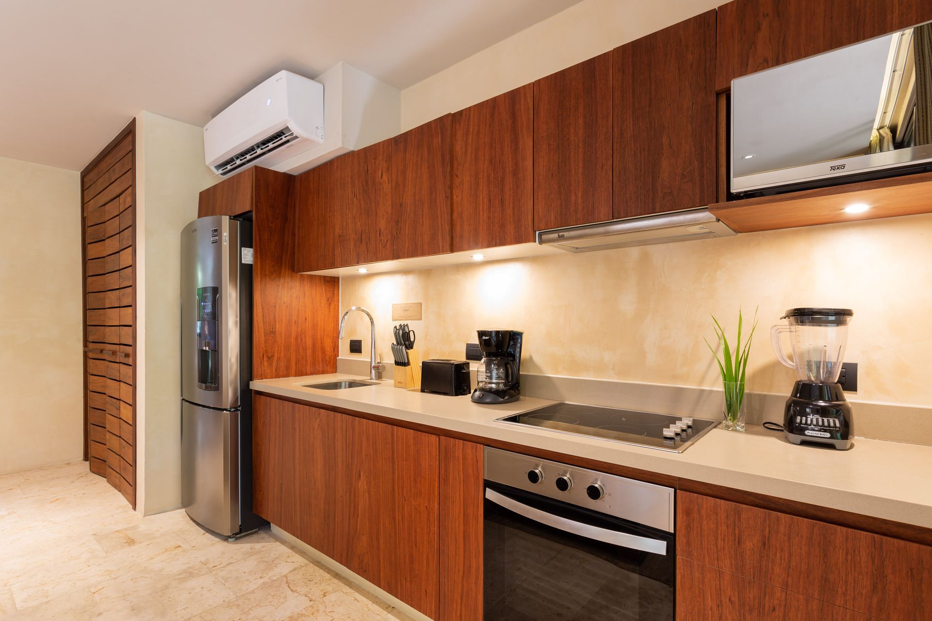 A kitchen with stainless steel appliances and wooden cabinets.