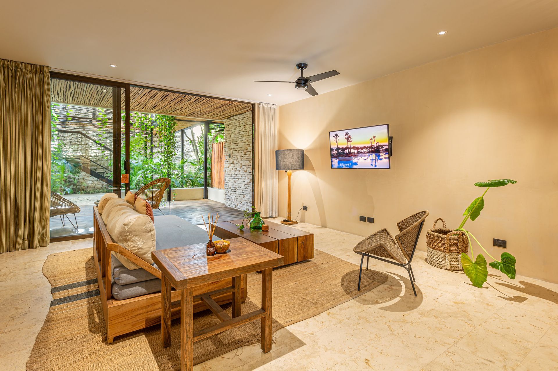 A living room with a couch , table , chairs and a television.